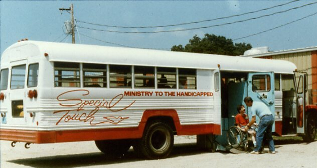 bus with STM logo on the side loading a person in a wheelchair old image from approx 1986
